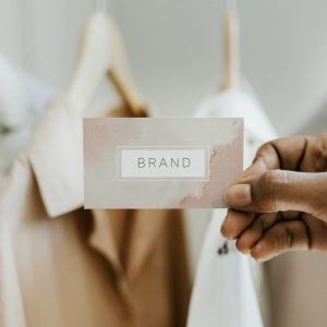 Hand holding business card at a boutique